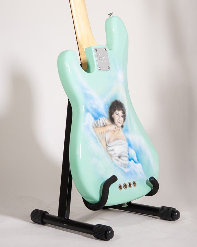 A guitar with a picture of a woman on it