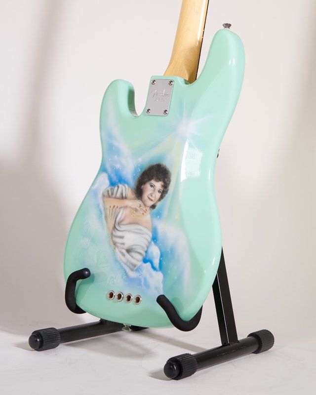 A guitar with a picture of a woman on it