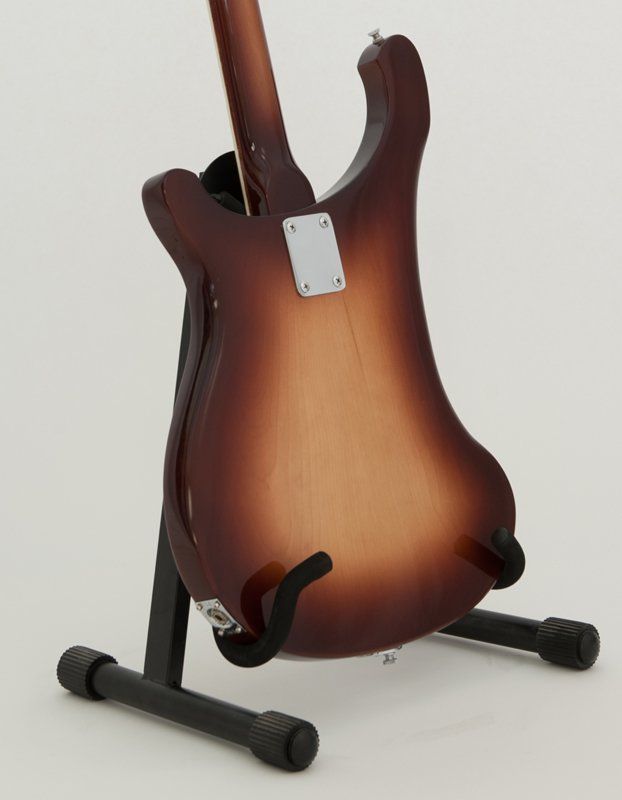 The back of a guitar is shown on a stand