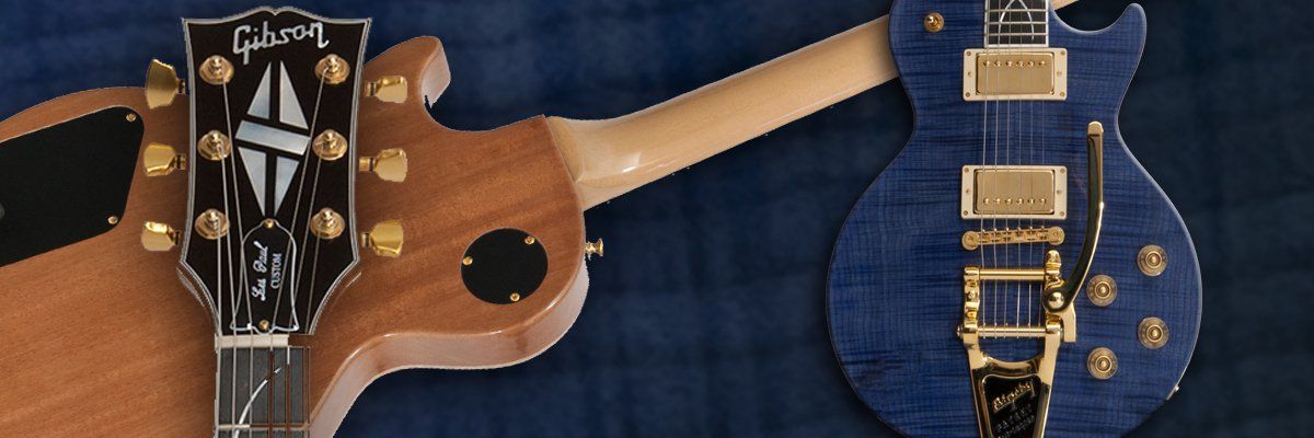 A blue gibson electric guitar is sitting on a blue cloth