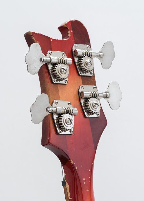 A close up of the headstock of a bass guitar