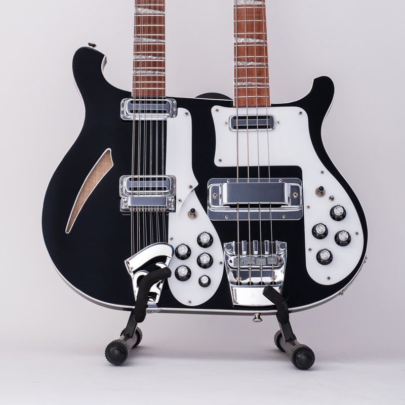 A black double neck guitar is sitting on a stand