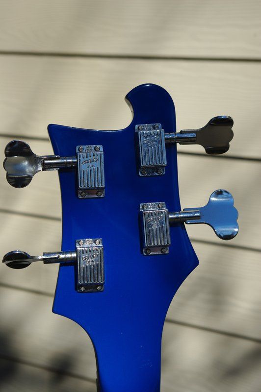 The back of a blue bass guitar is shown
