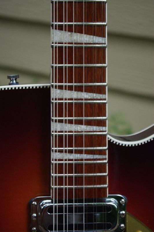 A close up of the neck of an electric guitar