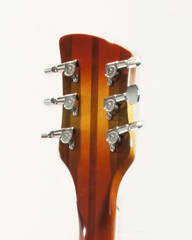 A close up of a guitar headstock on a white background