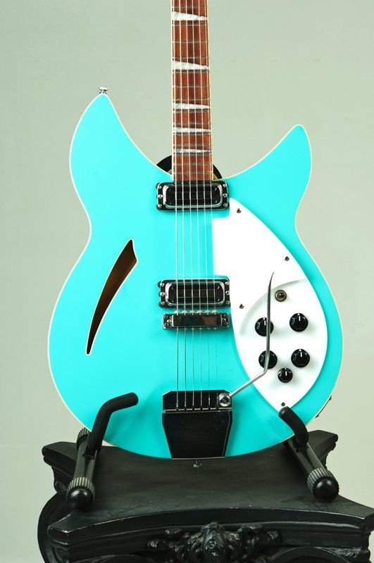 A blue guitar is sitting on a black stand