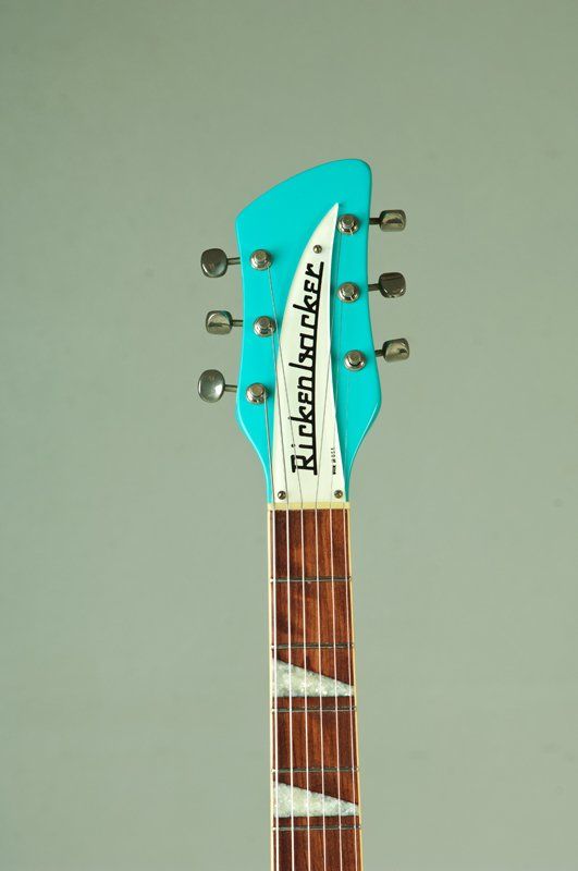 A close up of a rickenbacker electric guitar headstock