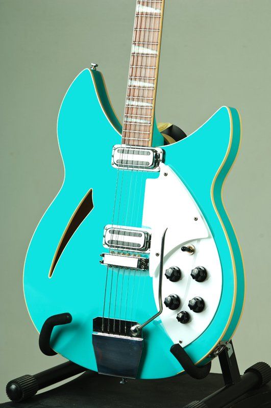 A blue and white guitar is sitting on a stand