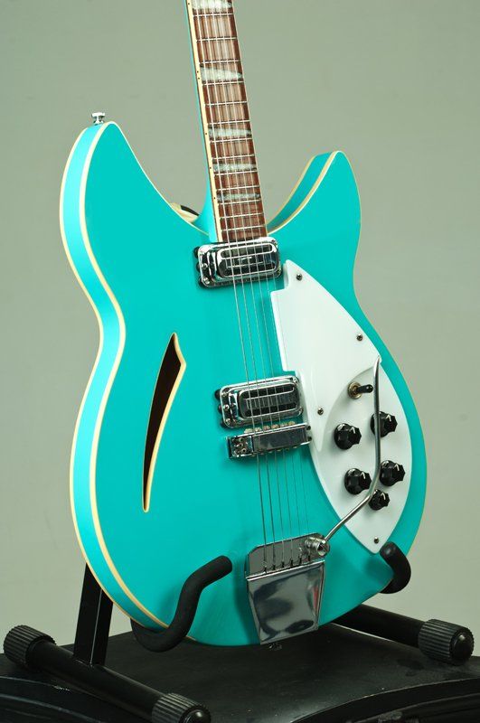 A blue and white guitar is sitting on a stand