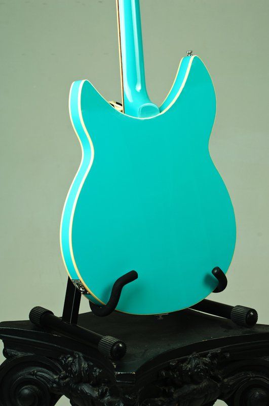 A blue guitar is sitting on a black stand