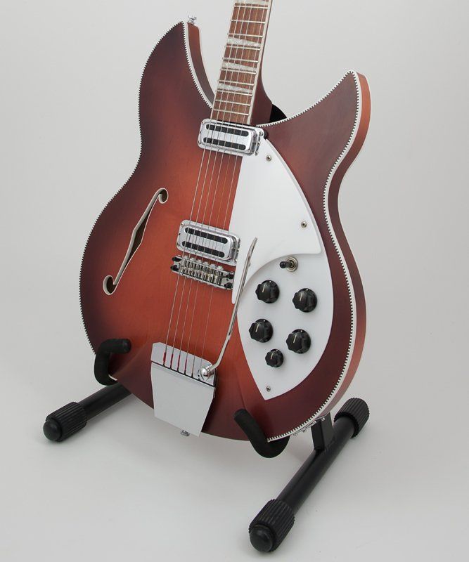 A brown and white guitar is sitting on a stand