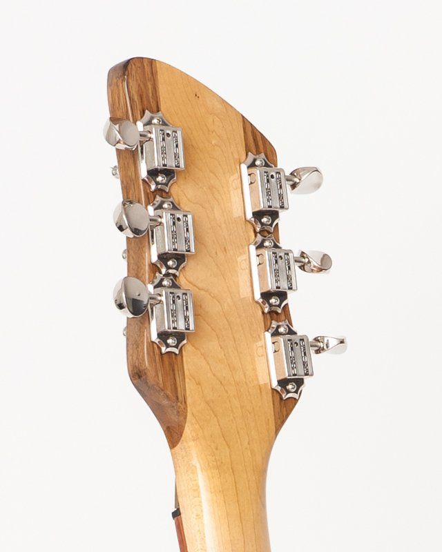 A close up of a guitar headstock on a white background