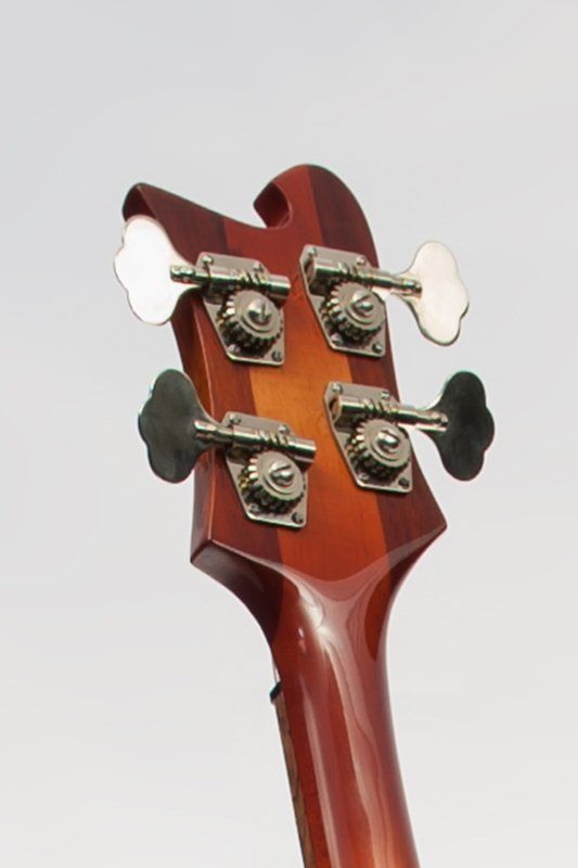 A close up of the headstock of a bass guitar