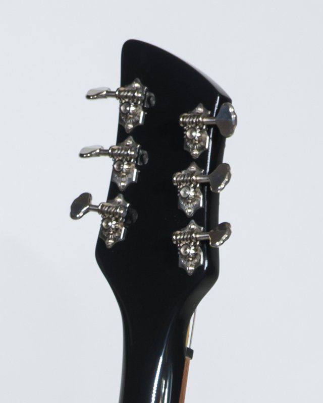 A close up of the headstock of an electric guitar