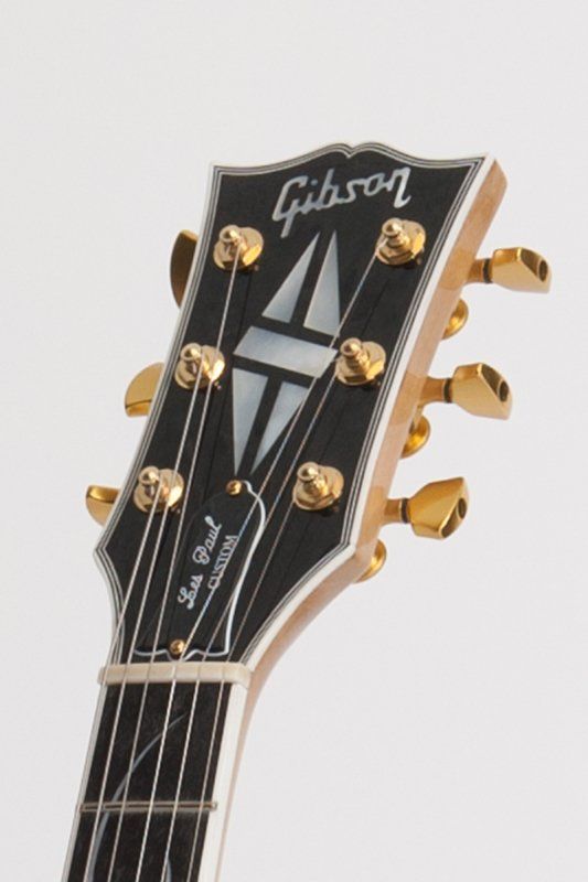 A close up of the headstock of a gibson guitar