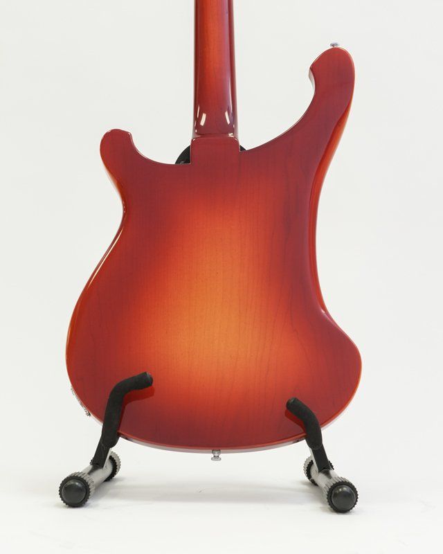 The back of a red electric guitar on a stand