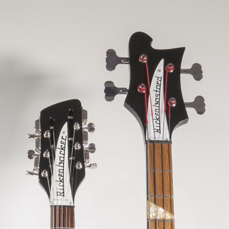 A rickenbacker bass guitar is next to a rickenbacker guitar