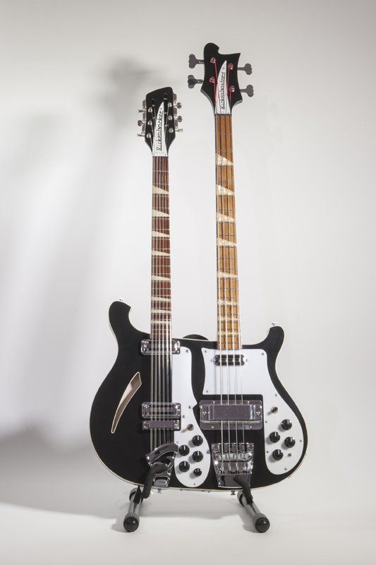 A double neck guitar and a double neck bass guitar on a stand