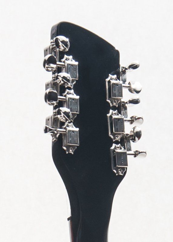 A close up of a guitar headstock on a white background