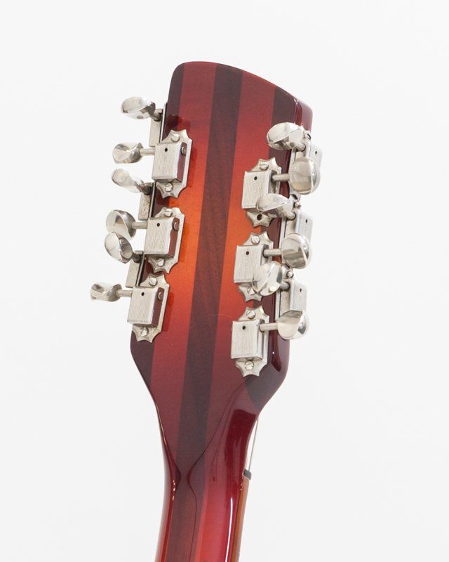 A close up of a guitar headstock on a white background