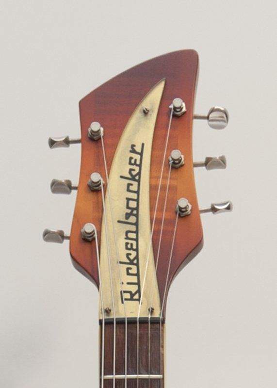 A close up of a rickenbacker guitar headstock