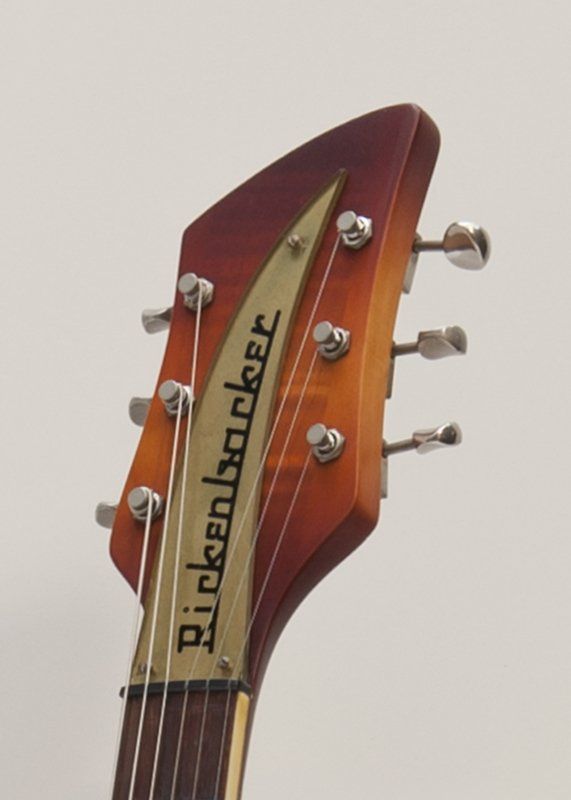A close up of a rickenbacker guitar headstock