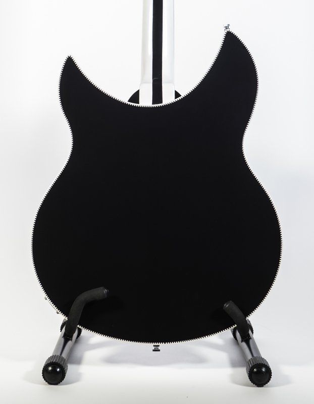 A black guitar is sitting on a stand on a white background