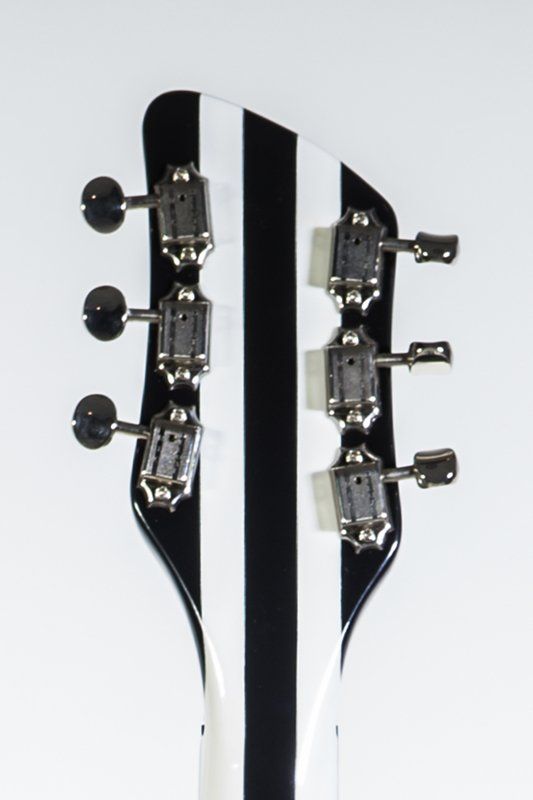 The headstock of a black and white striped guitar