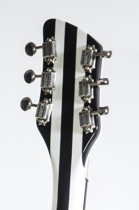 The headstock of a black and white striped guitar