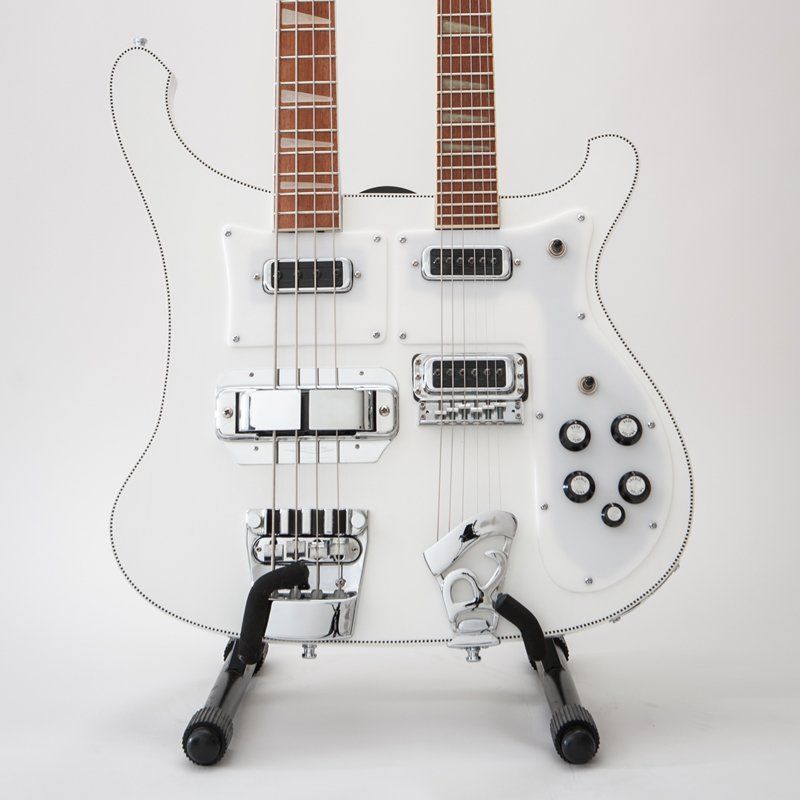 A white double neck guitar is sitting on a stand