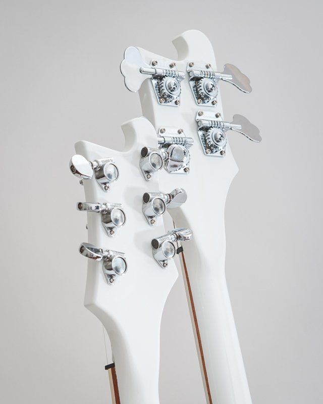 A close up of the back of a white electric guitar