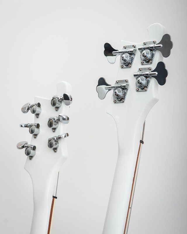 A close up of the back of a white guitar