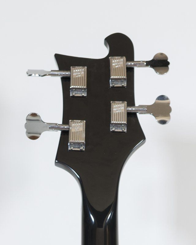A close up of the headstock of a bass guitar