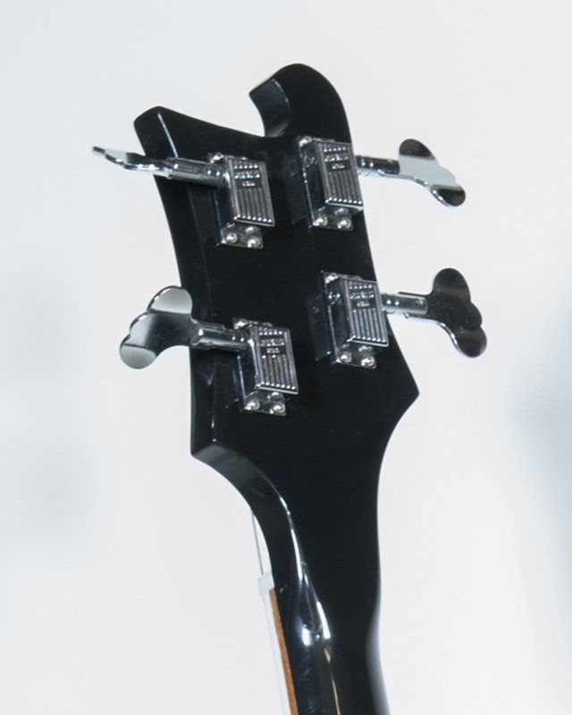 A close up of the headstock of a bass guitar