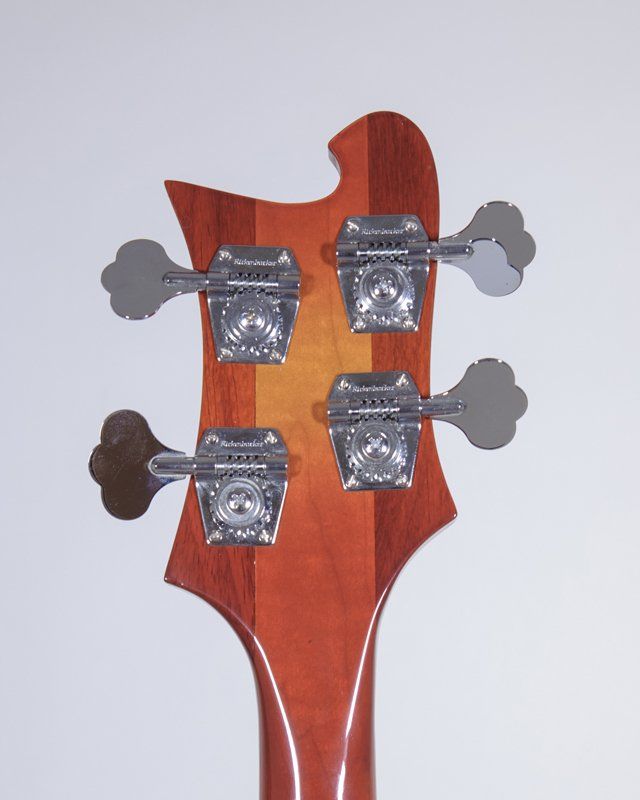 A close up of the headstock of a bass guitar