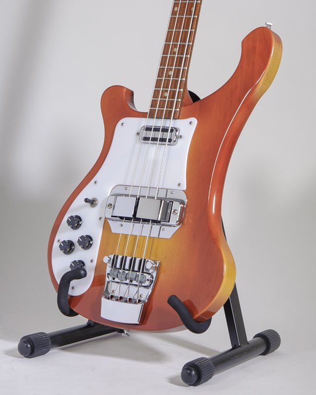 A bass guitar is sitting on a guitar stand