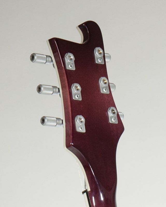 A close up of the headstock of an electric guitar
