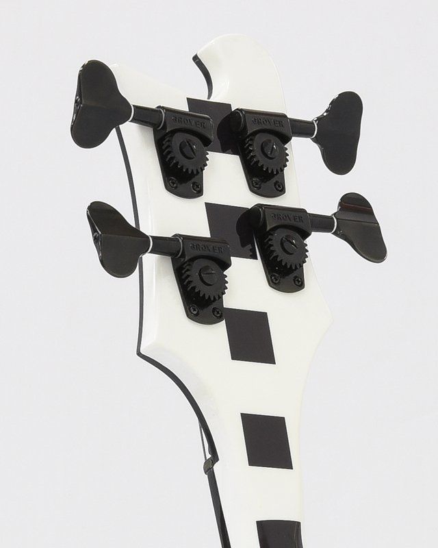 The headstock of a black and white bass guitar