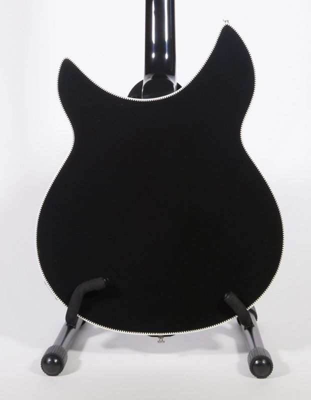 The back of a black guitar on a stand