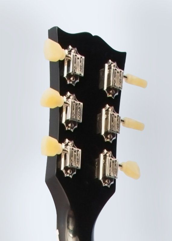 A close up of the headstock of a guitar