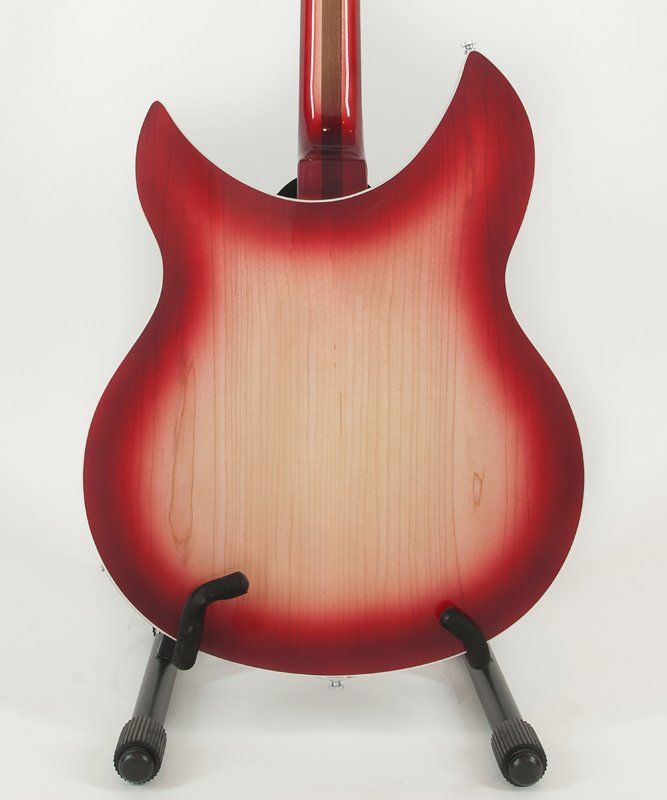 The back of a red guitar is shown on a stand