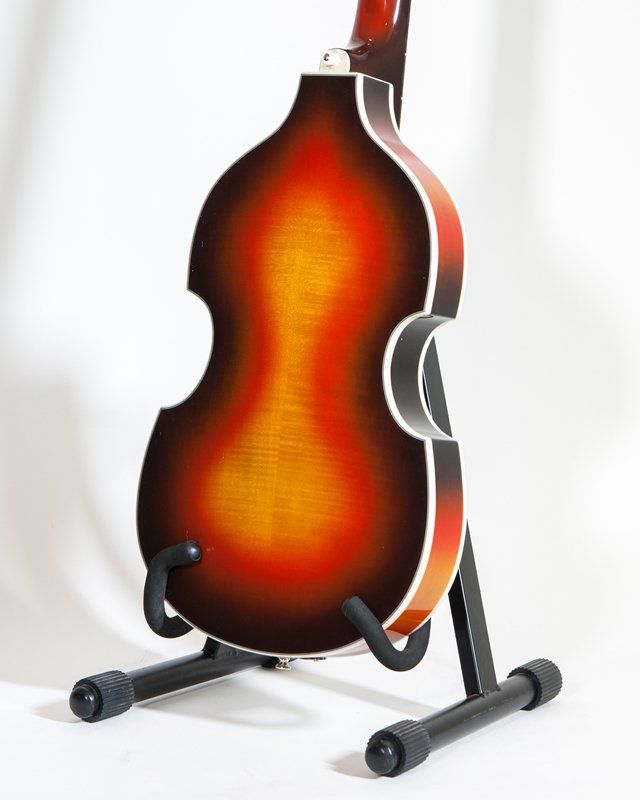 A double bass guitar is sitting on a stand