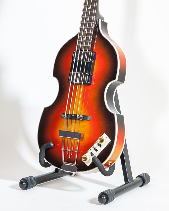 A double bass guitar is sitting on a stand