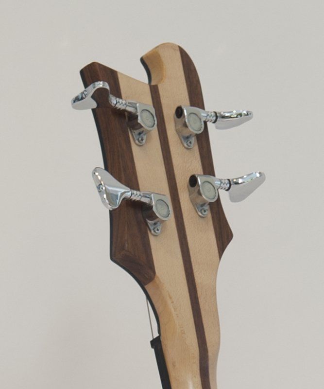 A close up of the headstock of a bass guitar