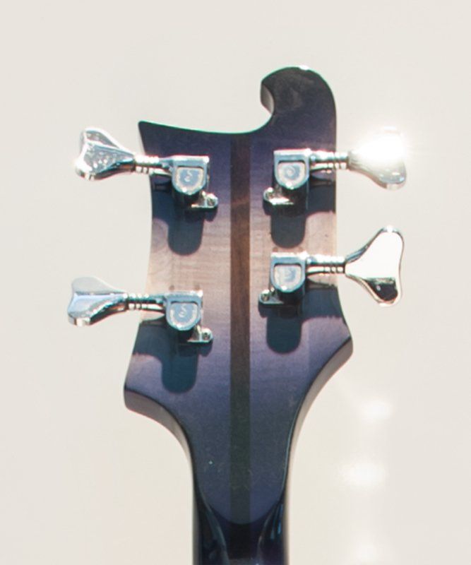 A close up of the headstock of a bass guitar