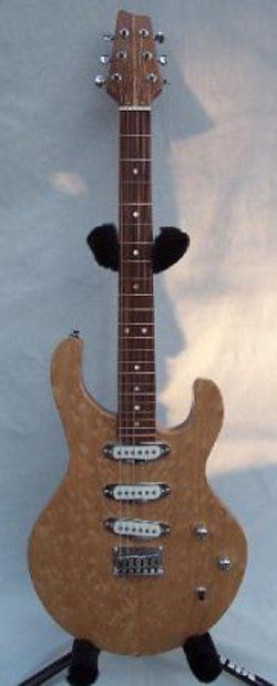 An electric guitar is sitting on a stand on a white surface.