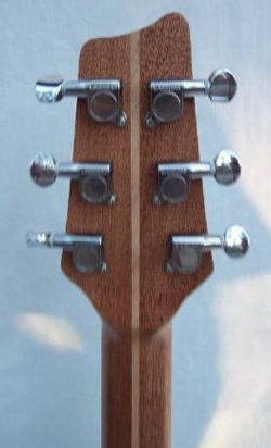 A close up of the headstock of an acoustic guitar