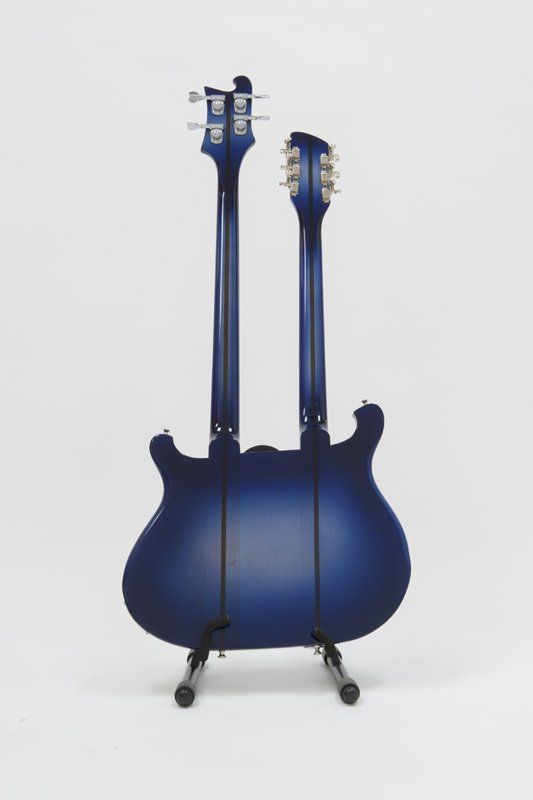 A blue guitar with two necks is sitting on a stand