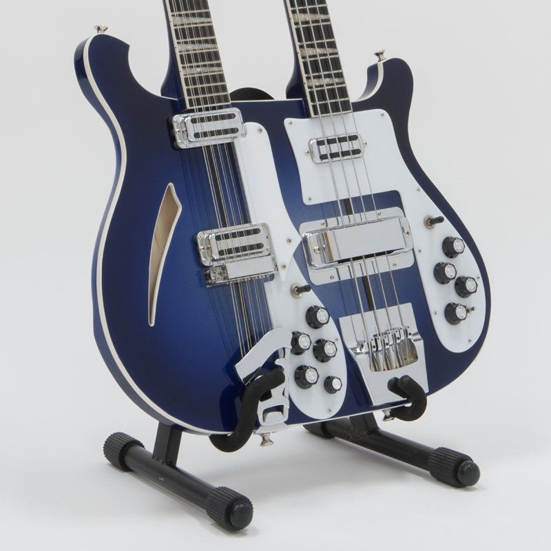 A blue double neck guitar is on a stand