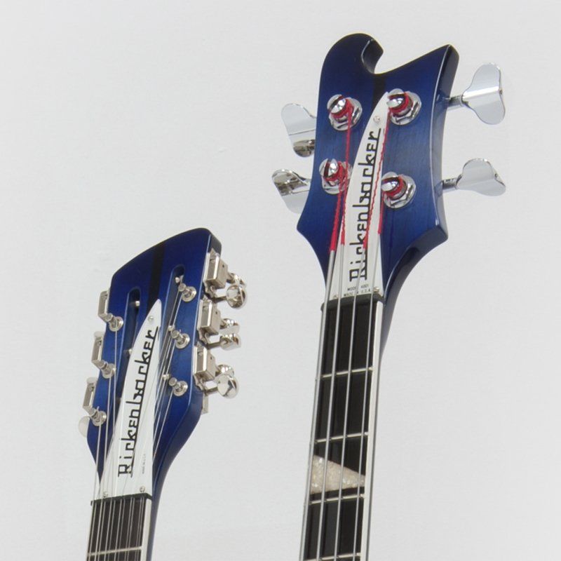 Two rickenbacker guitars are sitting next to each other